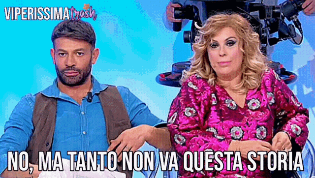 a man and a woman are sitting next to each other with the caption no ma tanto non va questa storia above them