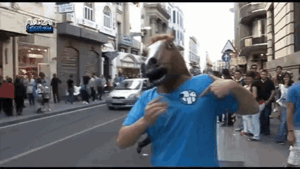 a man wearing a horse mask and a blue shirt that says 26 on it