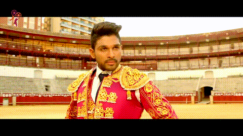 a man dressed as a matador stands in front of an empty arena