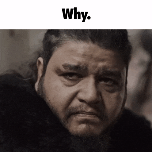 a man with a beard is looking at the camera with the caption why