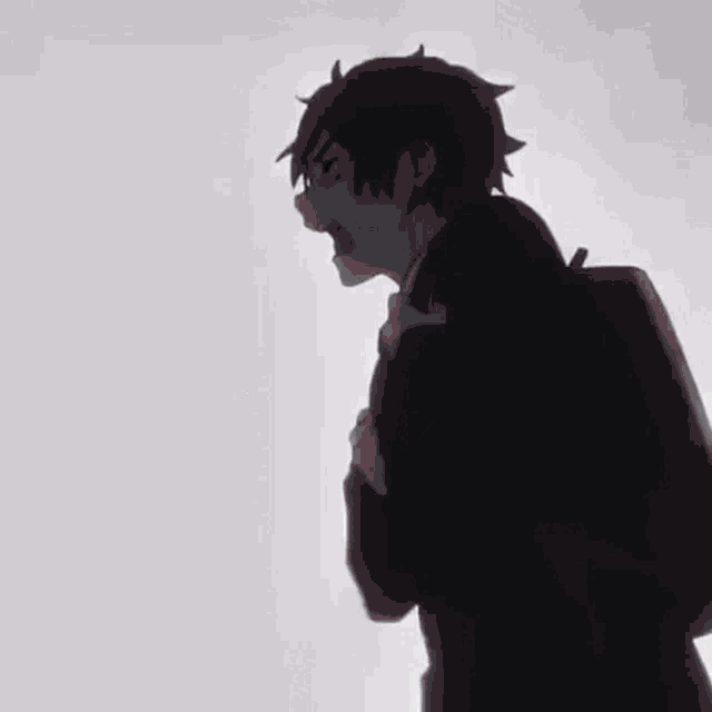 a black and white silhouette of a boy with a backpack standing in front of a white background .