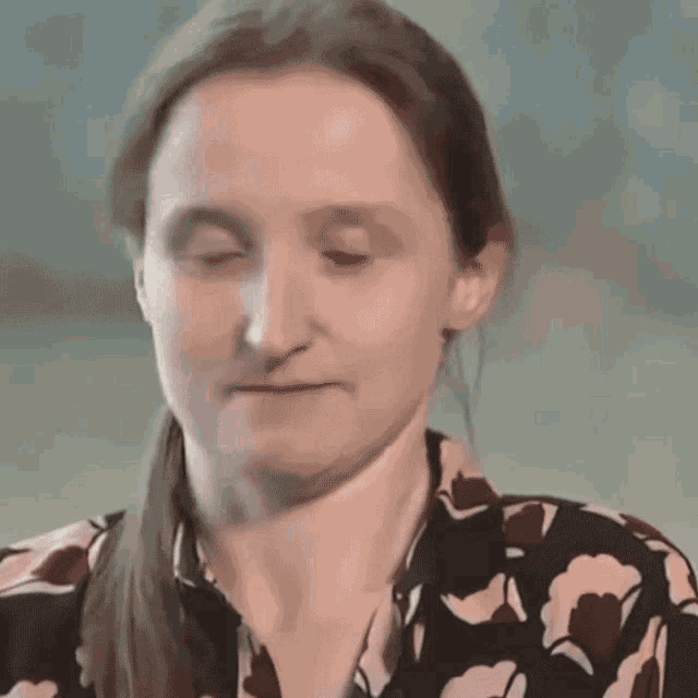 a close up of a woman 's face with a ponytail