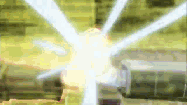 a blurred image of a person 's face with a few rays of light coming out of it