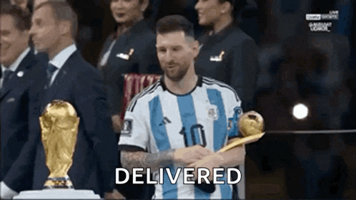 a soccer player is holding a trophy in front of a crowd and says delivered .