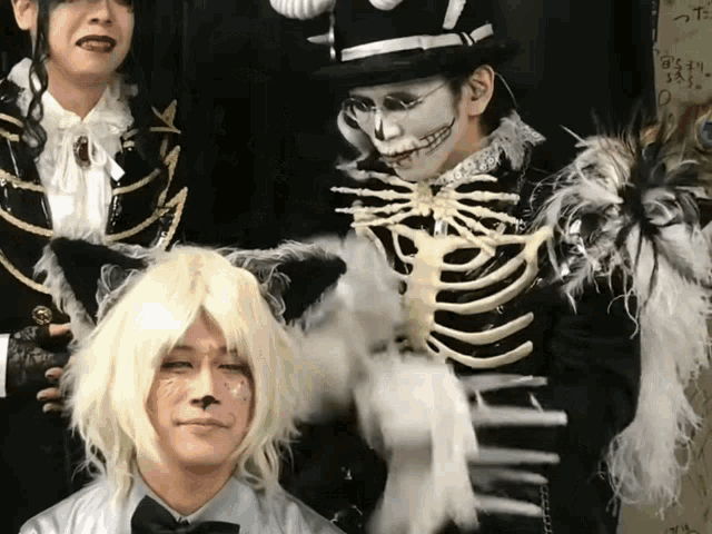 a group of people dressed in costumes including a skeleton and a cat