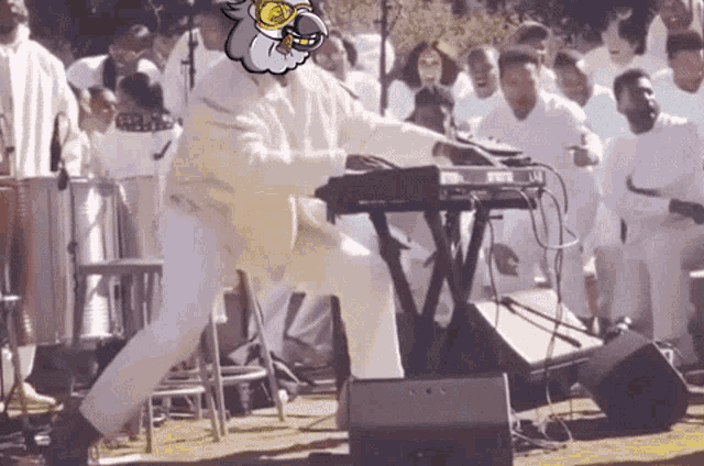 a man is playing a keyboard in front of a crowd of people