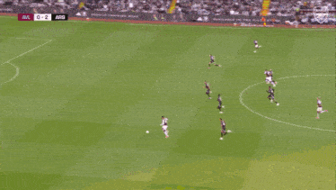 two soccer players are celebrating a goal and the score is 0-2