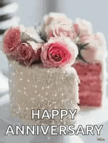 a cake with pink roses on top of it and the words `` happy anniversary '' below it .