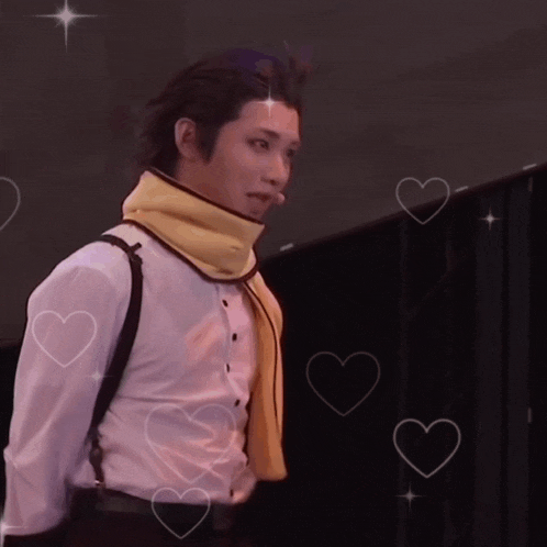 a man in a white shirt and yellow scarf is surrounded by hearts and stars