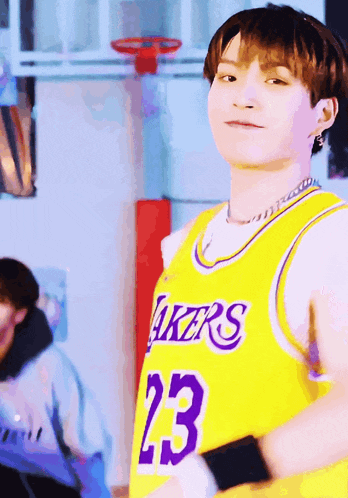 a young man wearing a lakers jersey with the number 23 on it