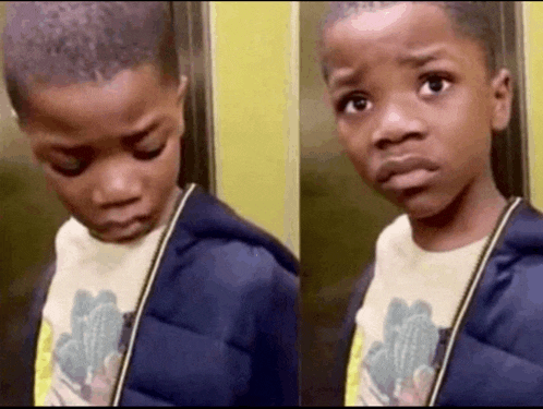 a young boy is standing in an elevator and making a sad face .