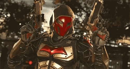 a man in a superhero costume is holding a sword in his hand .