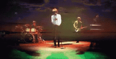 a group of people playing instruments on a stage