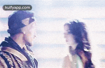 a man and a woman are looking at each other and talking .