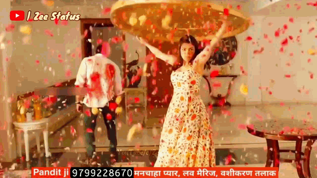 a man and a woman are dancing in a living room with petals falling on them .