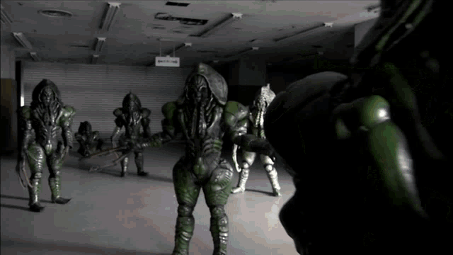 a group of aliens standing in a dark room