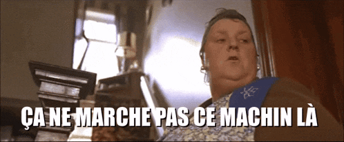 a woman is standing in a room with the words " ca ne marche pas ce machin la " above her