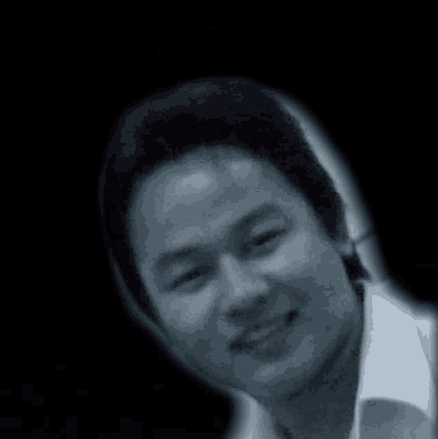 a black and white photo of a man smiling