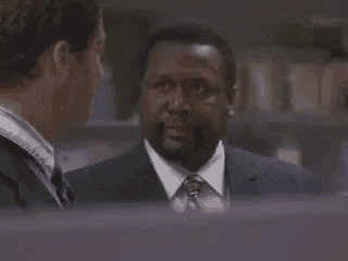 a man in a suit and tie is talking to another man in a suit and tie .