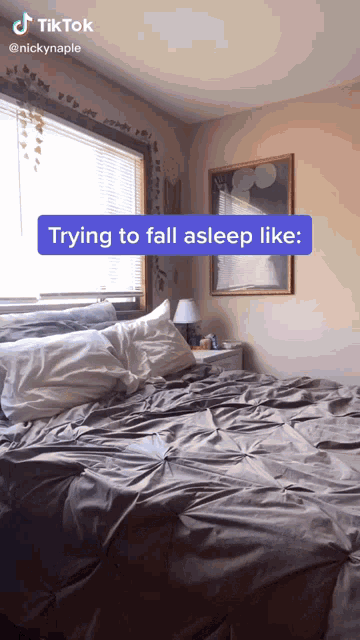 a bedroom with a bed and a sign that says ' trying to fall asleep like '