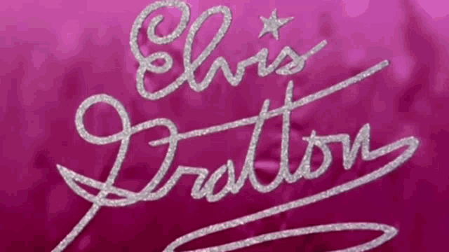the name elvis is written in silver on a pink cloth