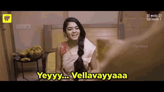 a woman sitting on a bed with the words yeyyy vellavayyaaa on the screen