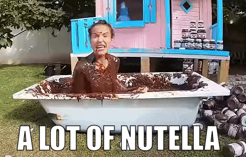 a woman is sitting in a bathtub covered in nutella with the caption a lot of nutella