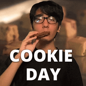 a man wearing glasses is eating a cookie with the words cookie day behind him