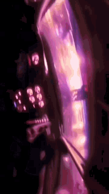 a blurry picture of a purple light coming out of a window