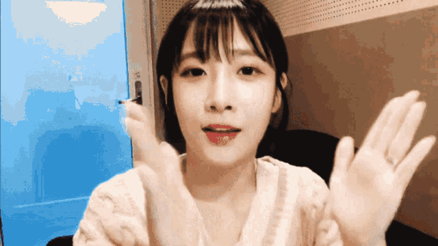 a girl with a ring on her finger is making a funny face