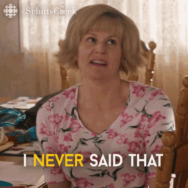 a woman in a floral shirt is sitting in a chair and says i never said that