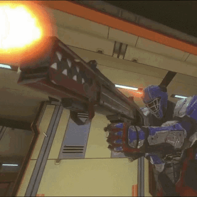 a video game character is holding a large gun with a red triangle on it