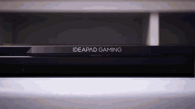 a black ideapad gaming device sits on a white surface