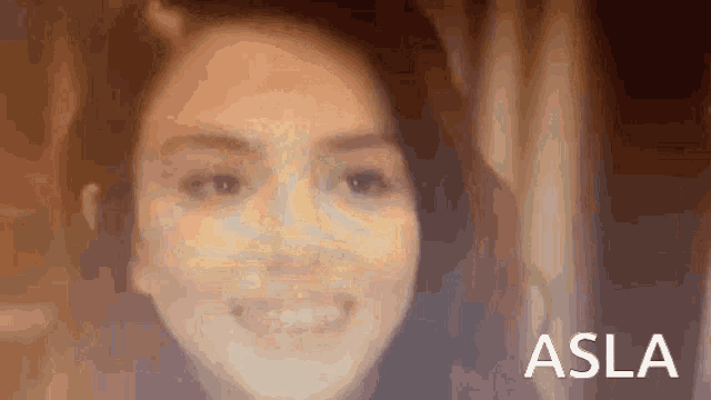 a close up of a woman 's face with the word asla on the bottom right