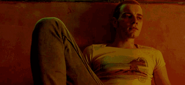 a man laying on the floor with his legs crossed