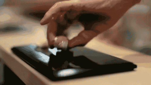 a close up of a person 's hand touching a phone
