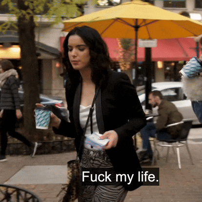a woman walking down the street with the words " fuck my life " on the bottom right