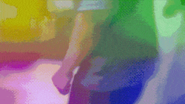 a blurry picture of a person 's feet with a rainbow of colors