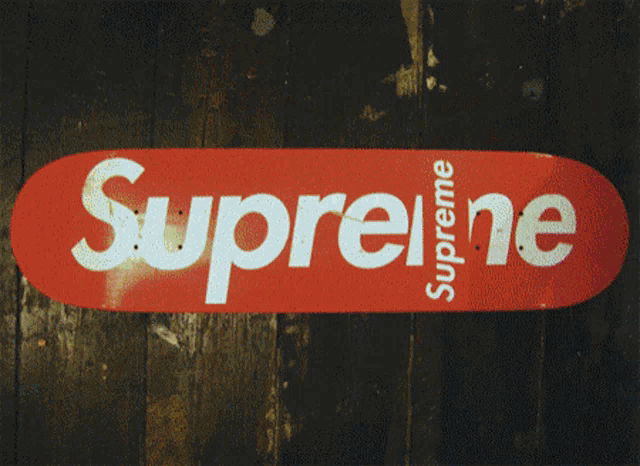 a plaid hat with supreme written on it