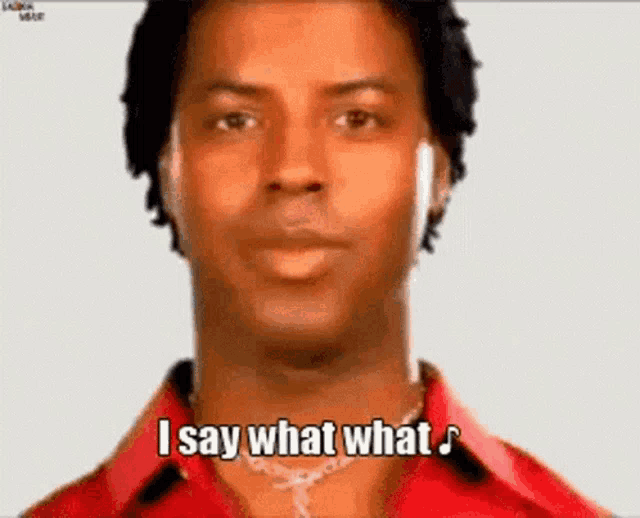 a man is wearing headphones and a red shirt and says `` i say what what '' .