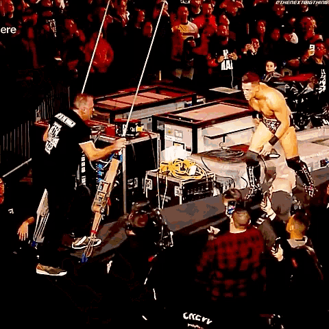 a man in a wrestling ring with the word atlanta on the wall