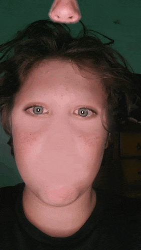 a close up of a person 's face with a nose on top