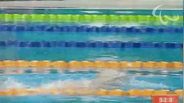 a person is swimming in a pool with a sign that says 53.8 on it