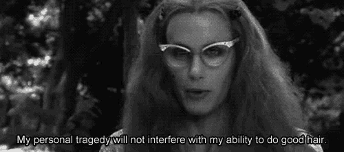 a woman wearing glasses says " my personal tragedy will not interfere with my ability to do good hair "