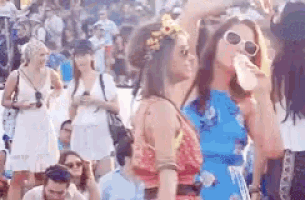 a group of people are standing in a crowd at a festival .