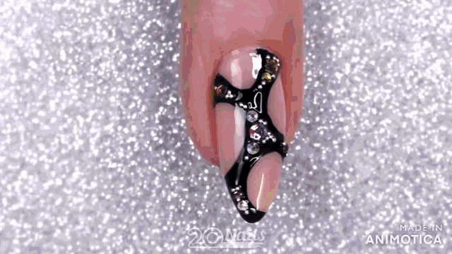 a close up of a woman 's nails with a black design