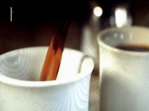 a cup of coffee with a spoon in it and the letter i on the bottom