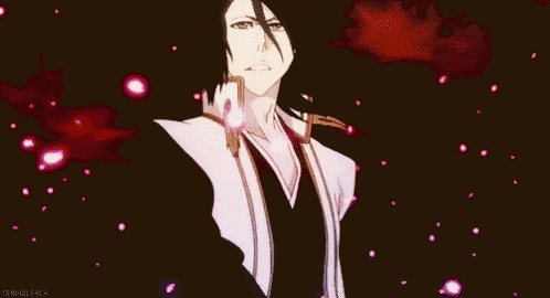 a man in a suit is standing in front of a red background surrounded by cherry blossoms .
