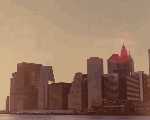 a city skyline with pier 17 in the distance