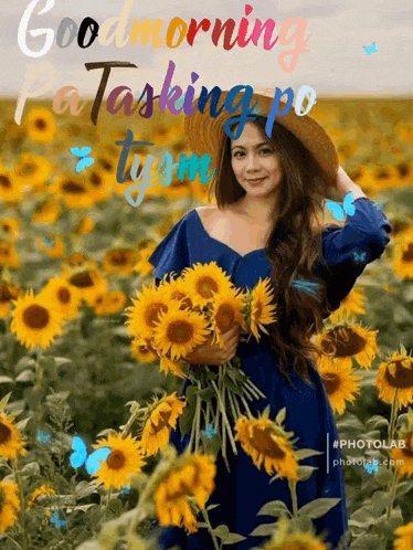a woman in a blue dress is holding a bouquet of sunflowers in a field of sunflowers